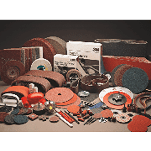 A variety of abrasive tools and products from Scott's Hill Hardware, including discs, wheels, and pads, are displayed in an organized manner. Packaging boxes are visible in the background.