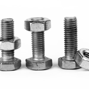 Four metal bolts with nuts, arranged upright in a line on a plain background. One bolt is paired with a nut placed horizontally, and another nut is shown separately. Perfectly assembled and available at Scott's Hill Hardware.